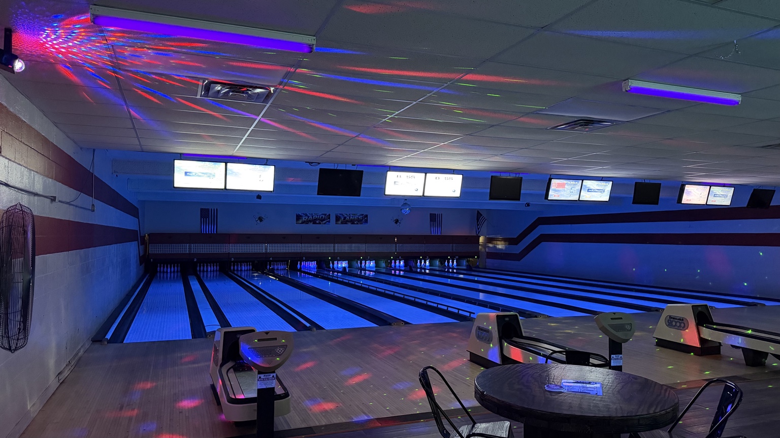 Cosmic bowling lanes glowing blue at Rapid Lanes